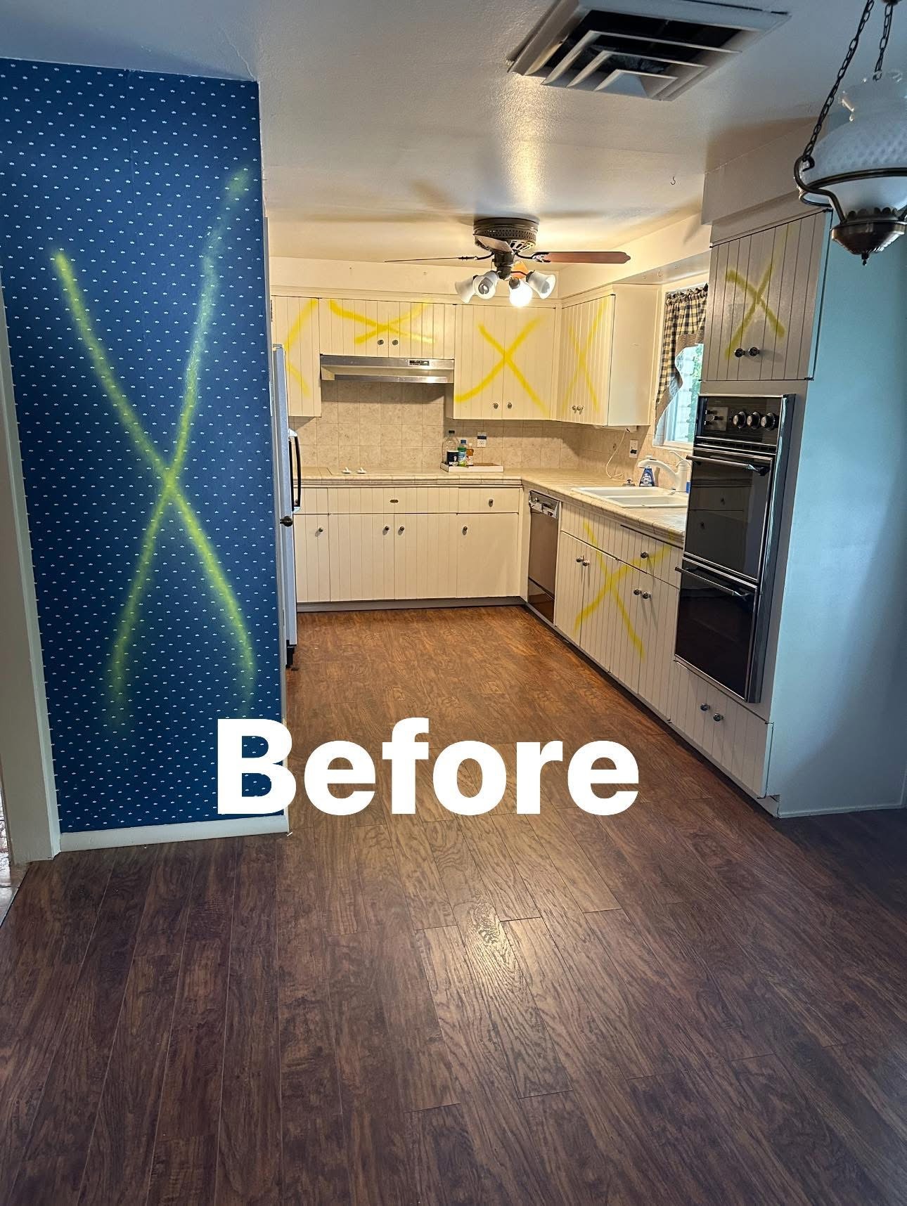 Before: dated El Paso kitchen with oak cabinets and dark laminate flooring