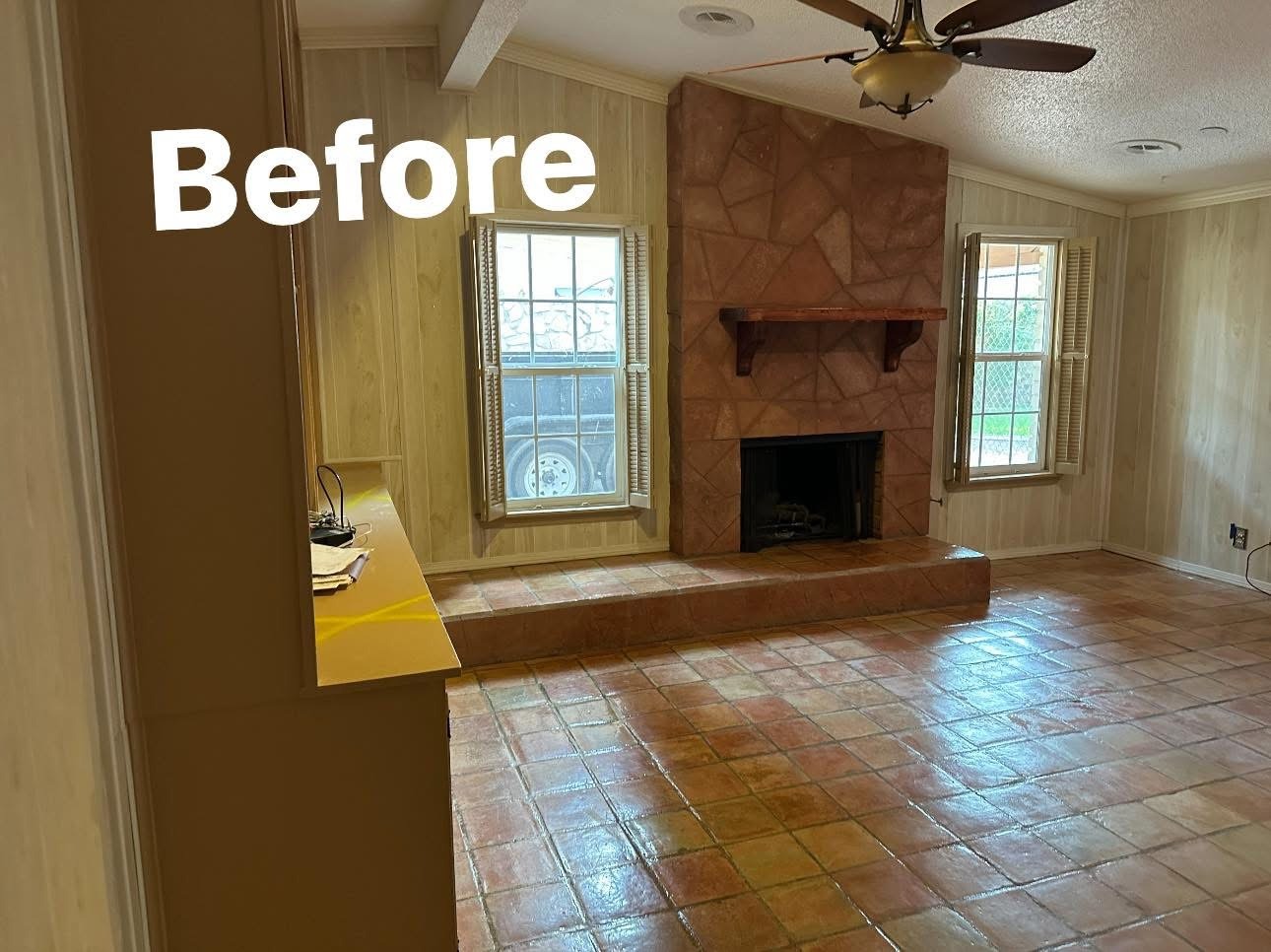 Before: original living room with brick fireplace and terracotta tile floor in El Paso